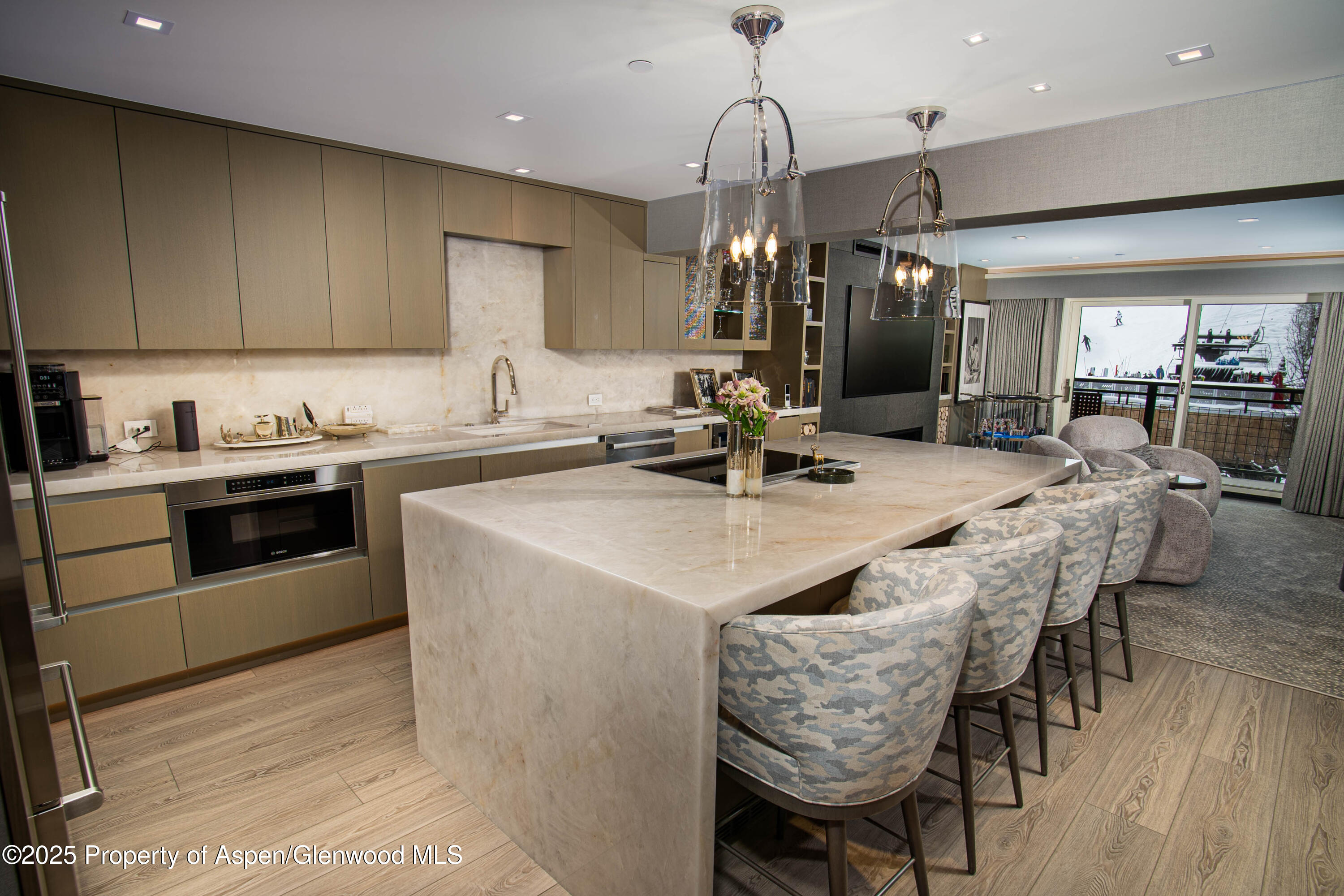 555 East Durant Avenue, Unit 3C Aspen, CO 81611 - Photo 8 of 16 a kitchen with stainless steel appliances granite countertop a sink a stove and a wooden floors