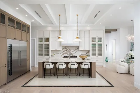 a large living room with stainless steel appliances granite countertop a couch and a view of living room