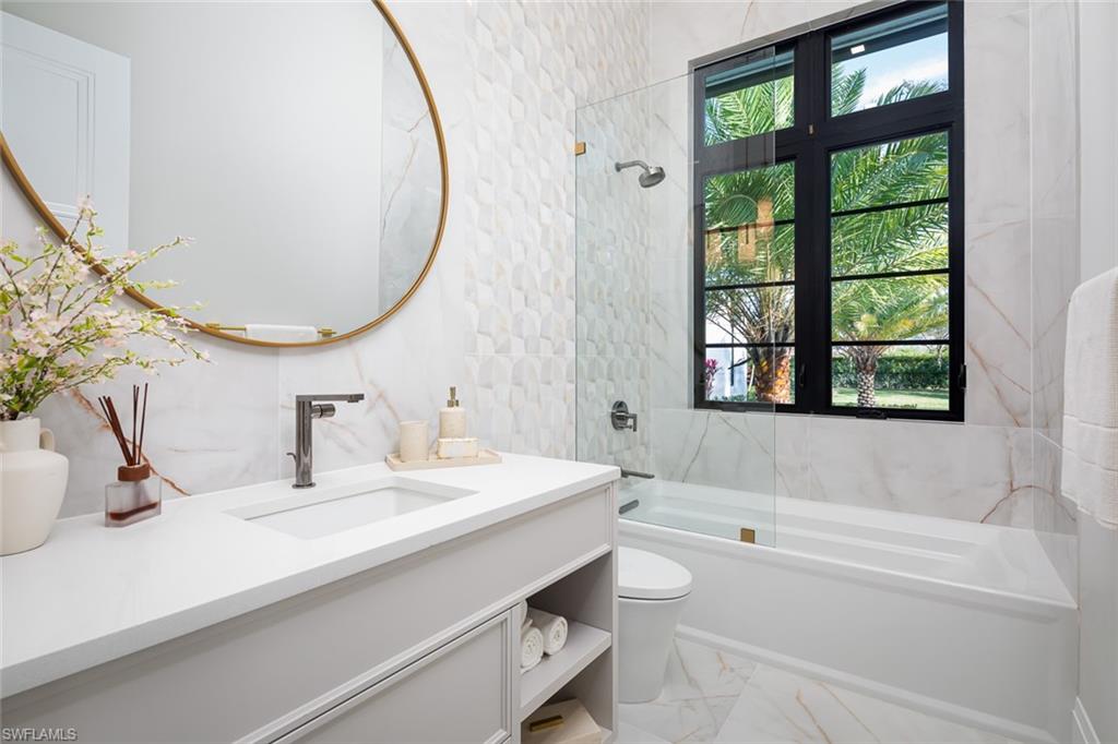 445 West Street Naples, FL 34108 - Photo 33 of 40 a bathroom with a sink and a mirror