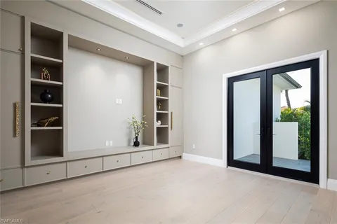 an empty room with windows and closet