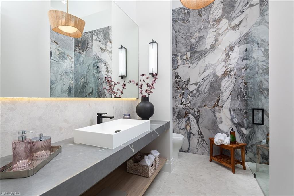 445 West Street Naples, FL 34108 - Photo 39 of 40 a bathroom with a sink and a mirror