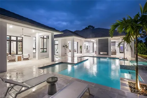 a view of a swimming pool with an outdoor space and seating area