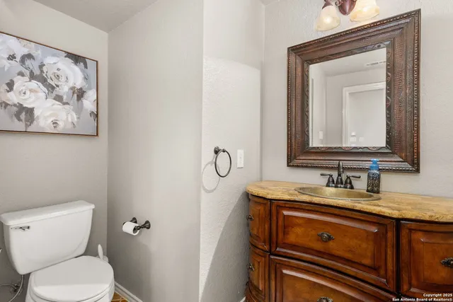a bathroom with a toilet sink and mirror