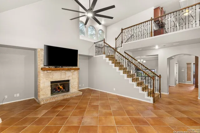 a view of an empty room with a fireplace and a window