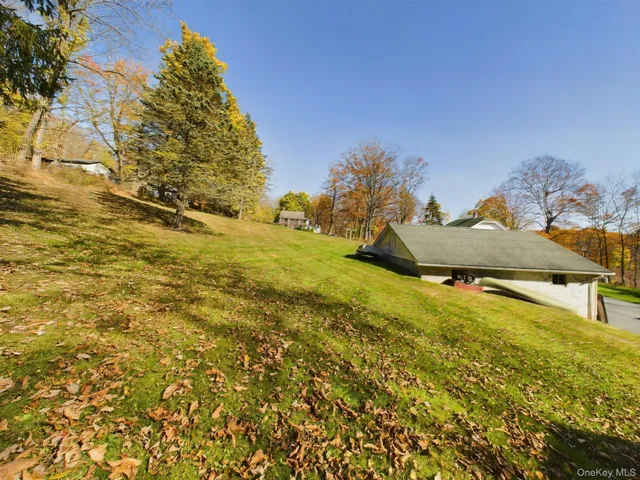 a view of a big yard with swimming pool and trees