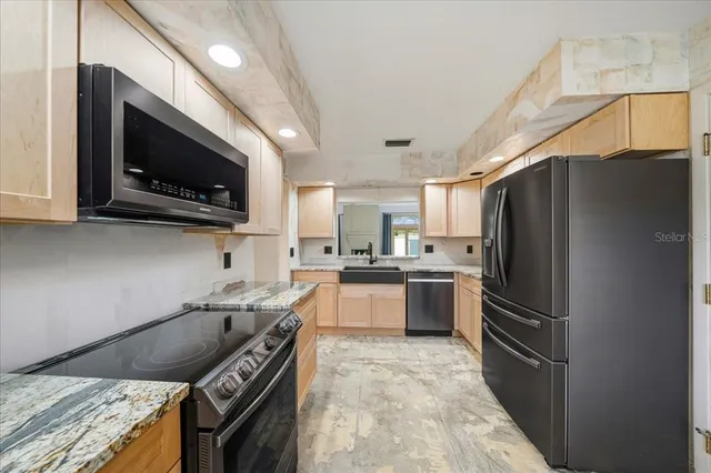 a kitchen with a sink stove and cabinets