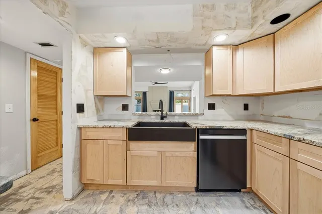 a kitchen with a stove a refrigerator and a sink