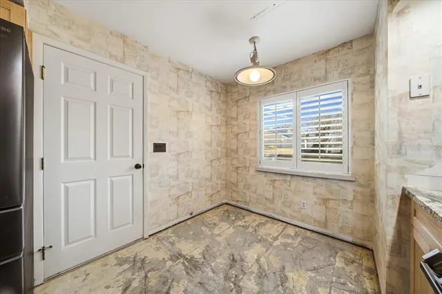 a view of empty room with a fireplace and windows