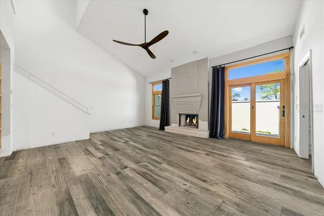 an empty room with a ceiling fan and entryway
