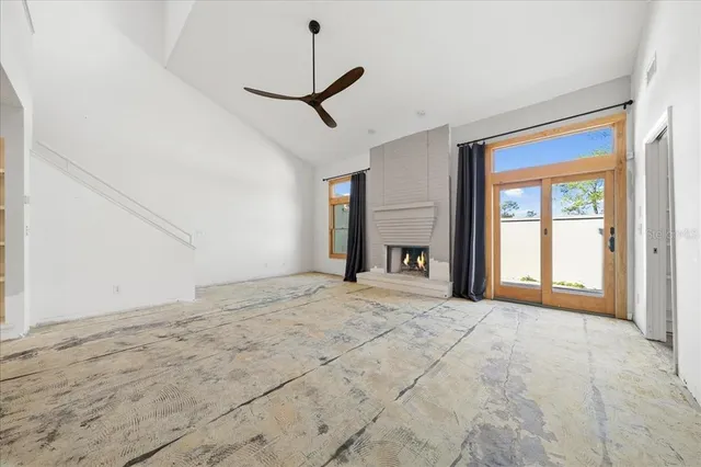 a view of an empty room with a window and closet