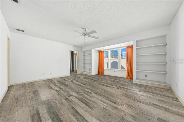 a view of a kitchen with a sink and refrigerator