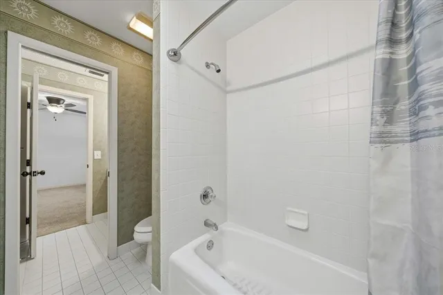 a view of a livingroom with a ceiling fan and window