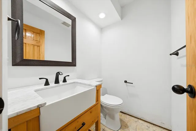 a bathroom with a toilet sink and mirror