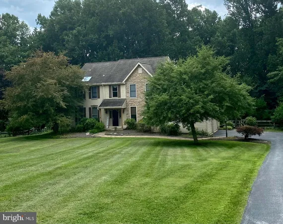 a aerial view of a house with swimming pool next to a big yard