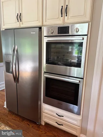 a stove top oven sitting inside of a kitchen