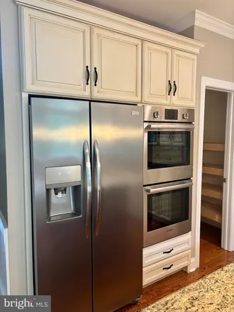 a kitchen with a refrigerator and microwave