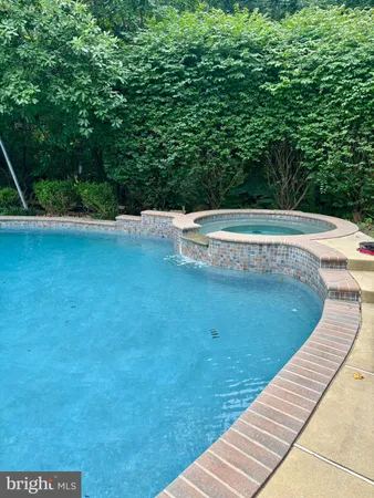 a view of a swimming pool with a yard