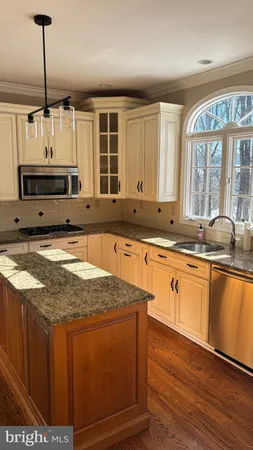 a kitchen with sink cabinets and window
