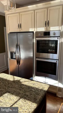 a kitchen with granite countertop a stove and a microwave