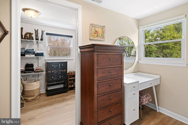 a kitchen with a wooden floor and a window