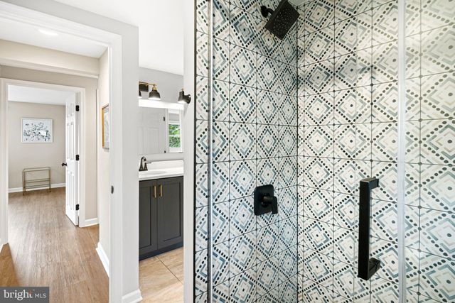 a picture of a bathroom with a sink and a shower