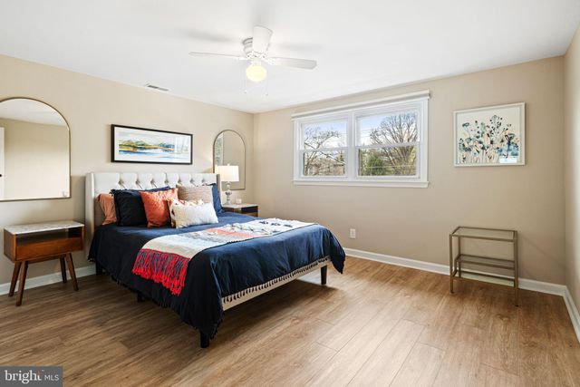 a spacious bedroom with a bed and a table