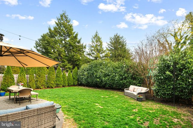 a view of a table and chairs under an umbrella