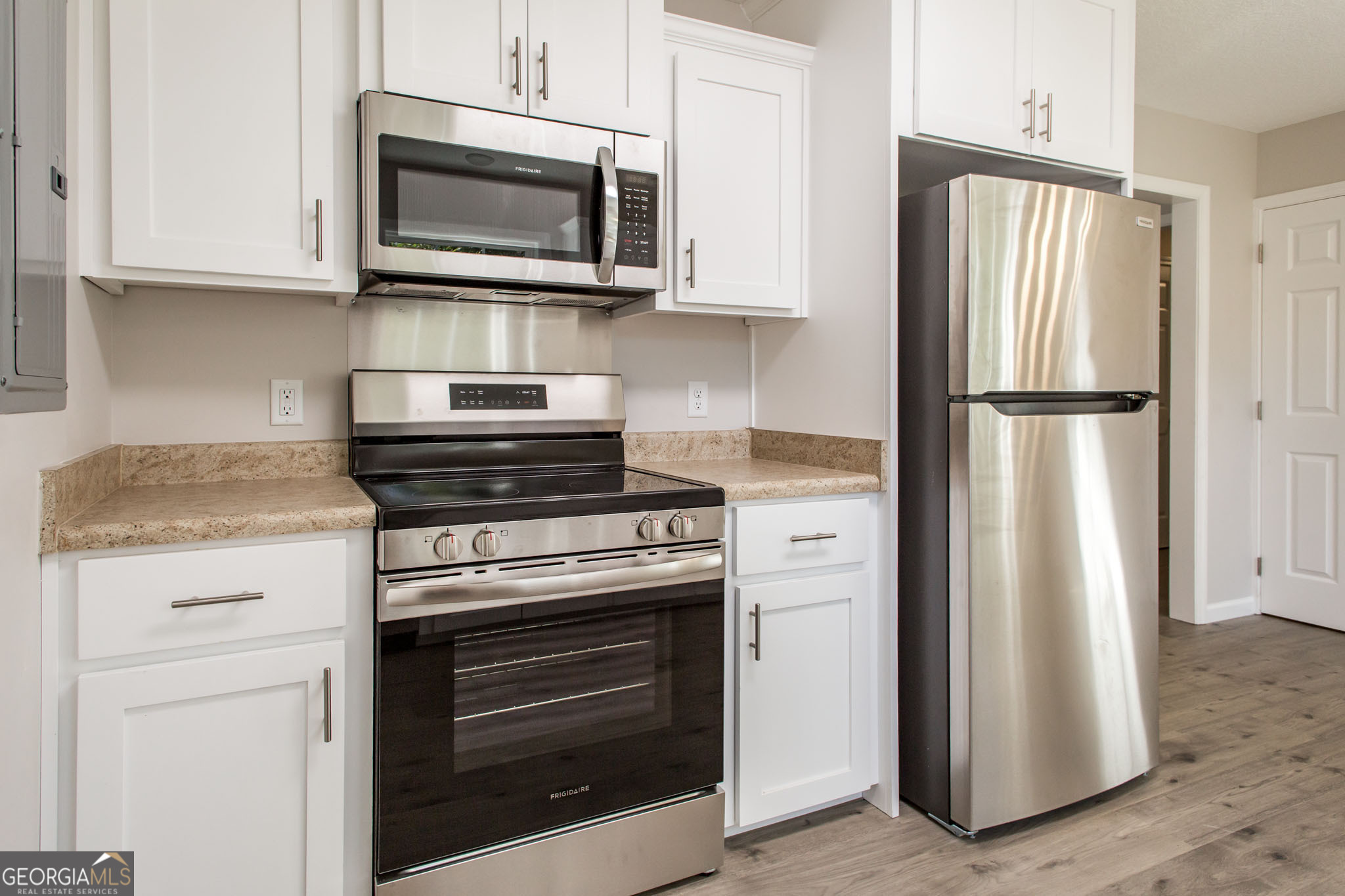 2350 Edgewood Street Waycross, GA 31501 - Photo 11 of 27 a kitchen with granite countertop white cabinets and stainless steel appliances