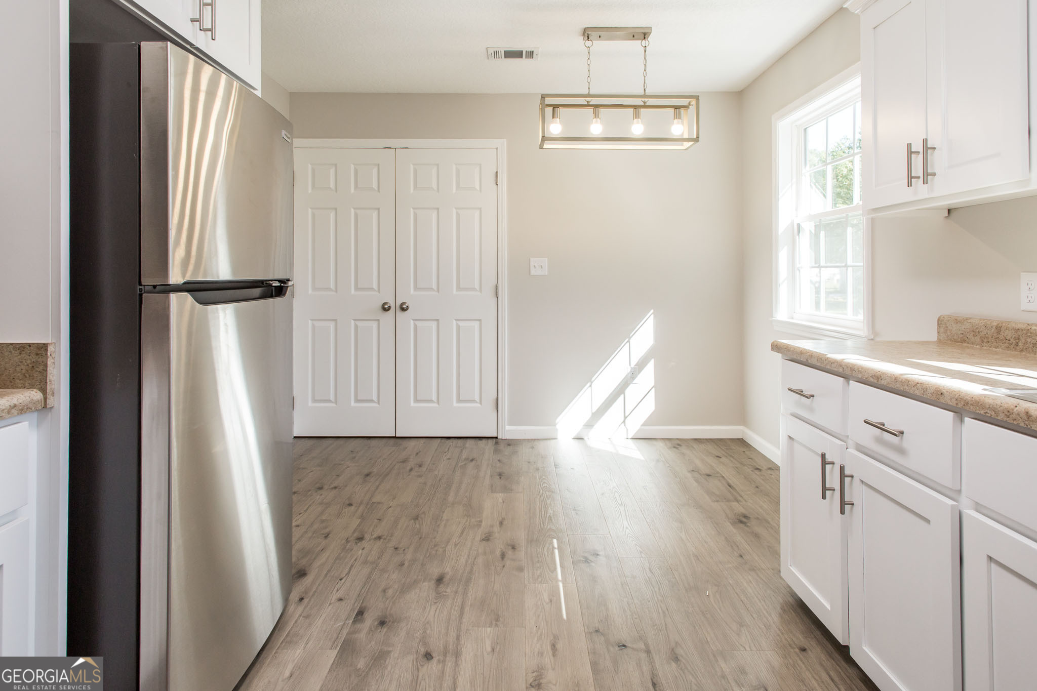 2350 Edgewood Street Waycross, GA 31501 - Photo 12 of 27 a view of a kitchen with wooden floor and electronic appliances