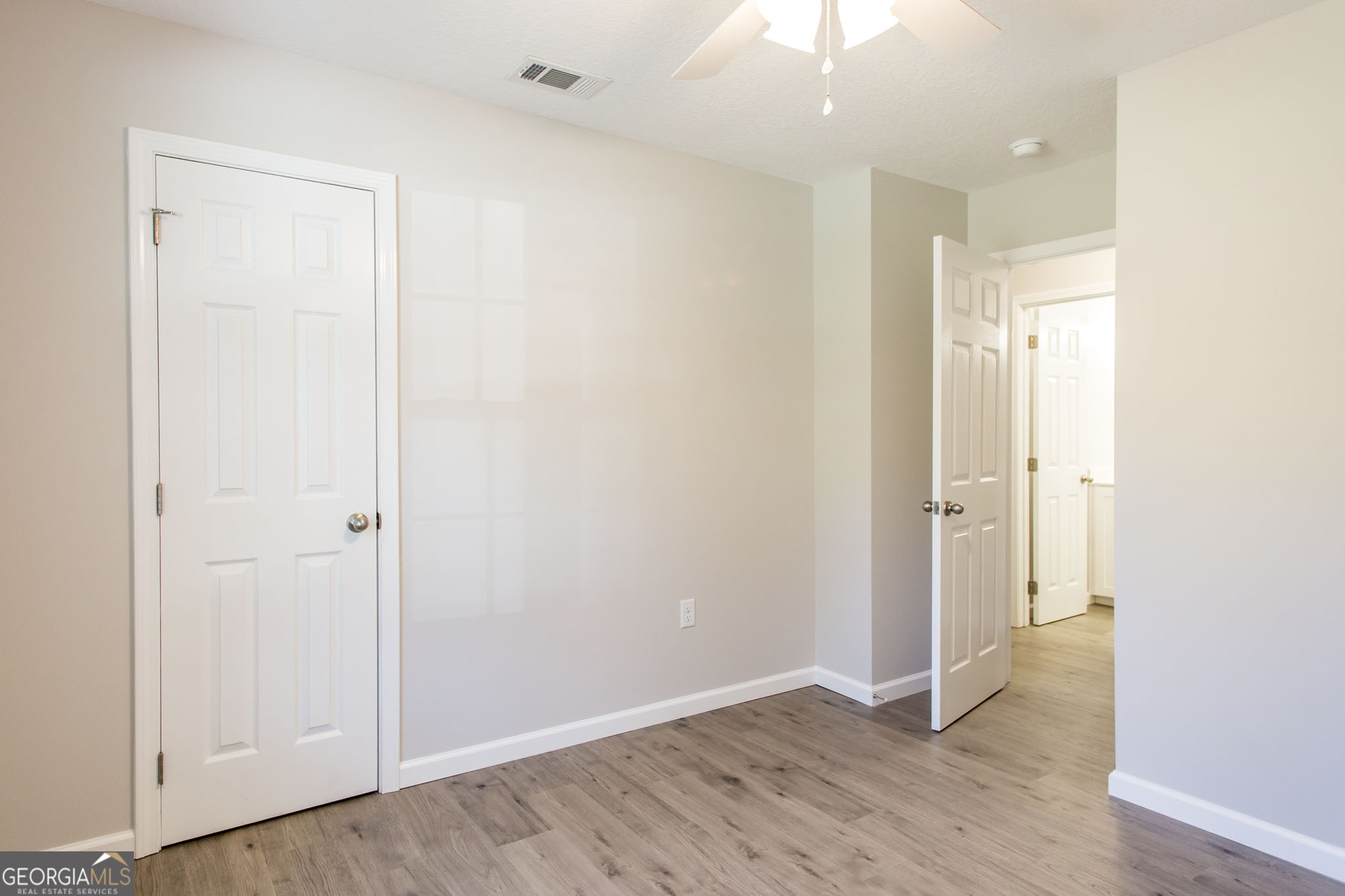 2350 Edgewood Street Waycross, GA 31501 - Photo 14 of 27 an empty room with wooden floor and closet area