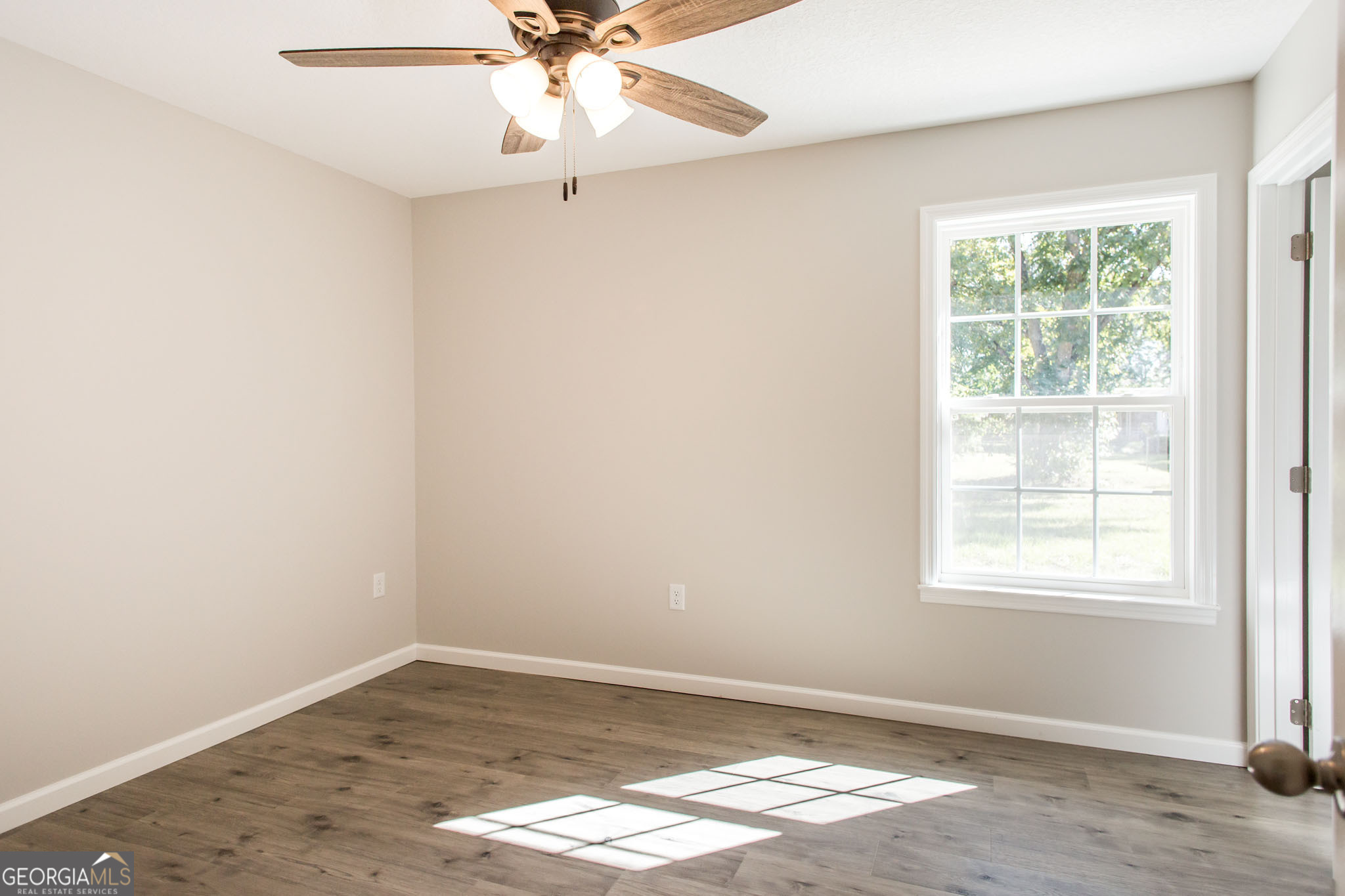 2350 Edgewood Street Waycross, GA 31501 - Photo 19 of 27 an empty room with a window and wooden floor