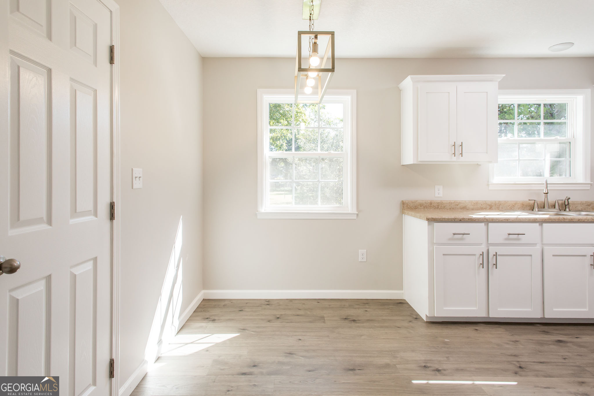 2350 Edgewood Street Waycross, GA 31501 - Photo 8 of 27 a view of a kitchen with wooden cabinets and window