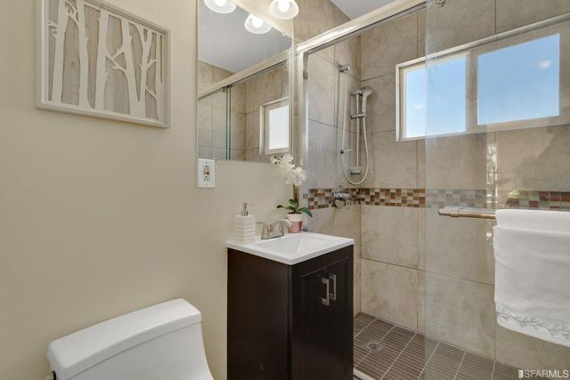 a bathroom with a sink toilet and mirror