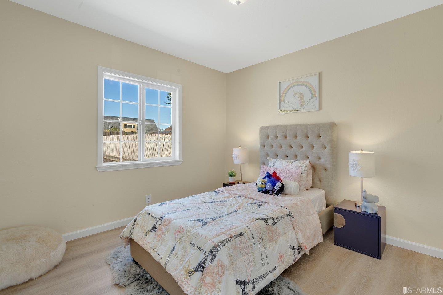 484 Lomond Drive Pacifica, CA 94044 - Photo 12 of 25 a bedroom with a bed and wooden floor