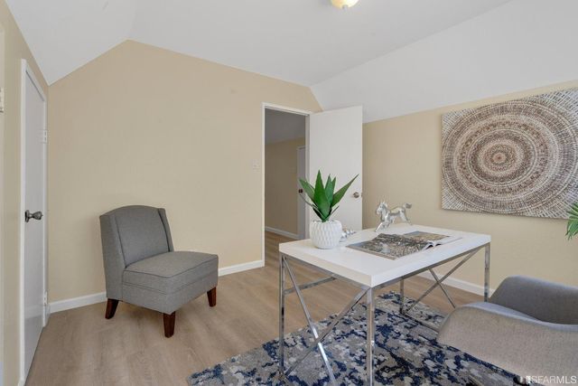a view of a workspace with furniture and rug