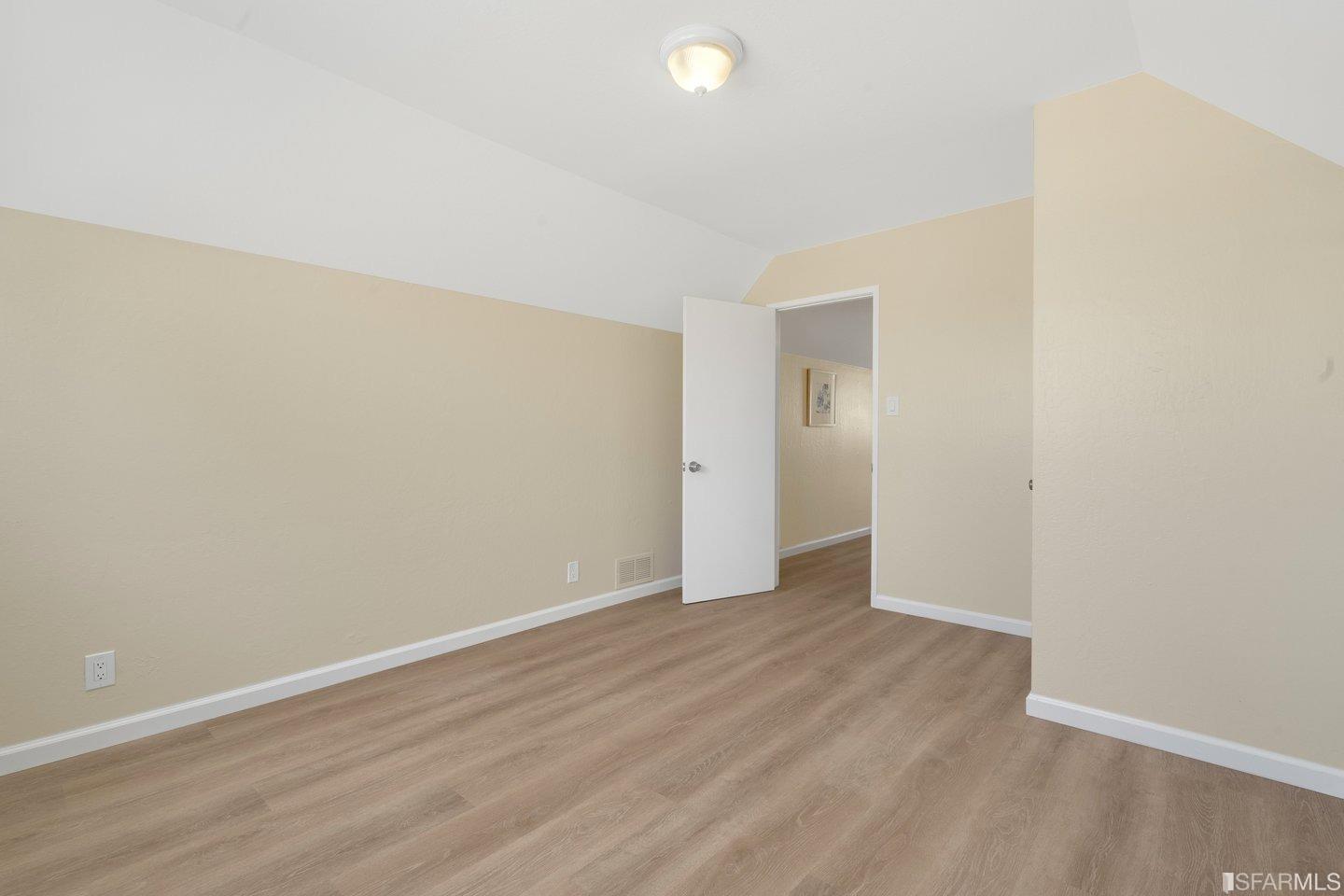 484 Lomond Drive Pacifica, CA 94044 - Photo 16 of 25 a view of an empty room with wooden floor
