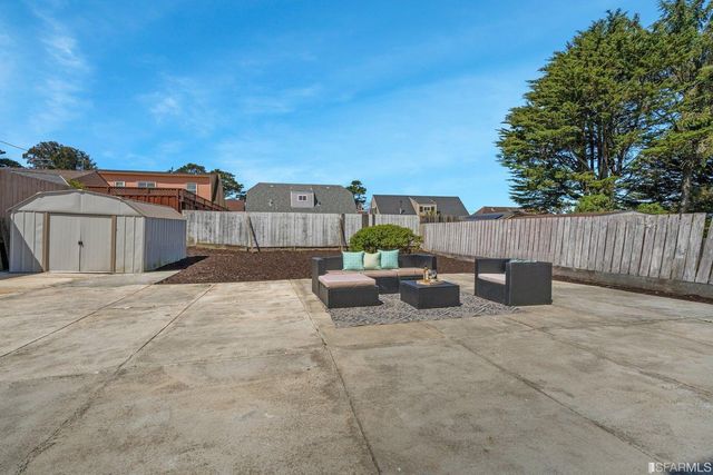 a terrace view with sitting space and wooden fence