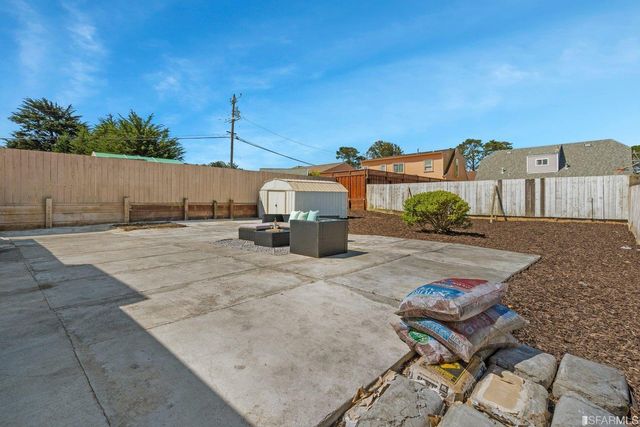 a view of a backyard of the house