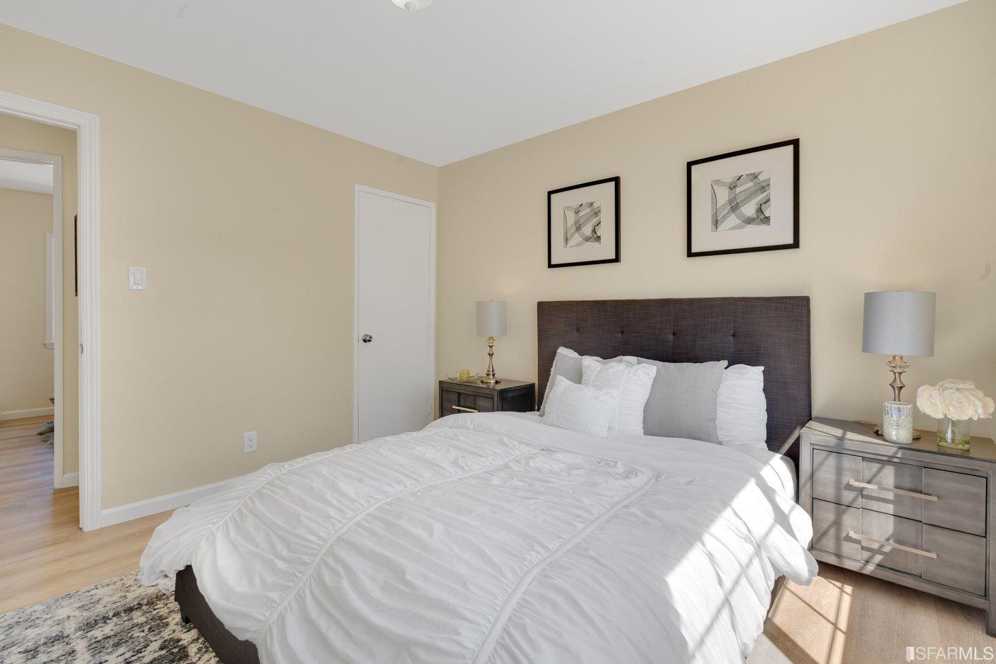 484 Lomond Drive Pacifica, CA 94044 - Photo 10 of 25 a bedroom with a bed and painting on the wall