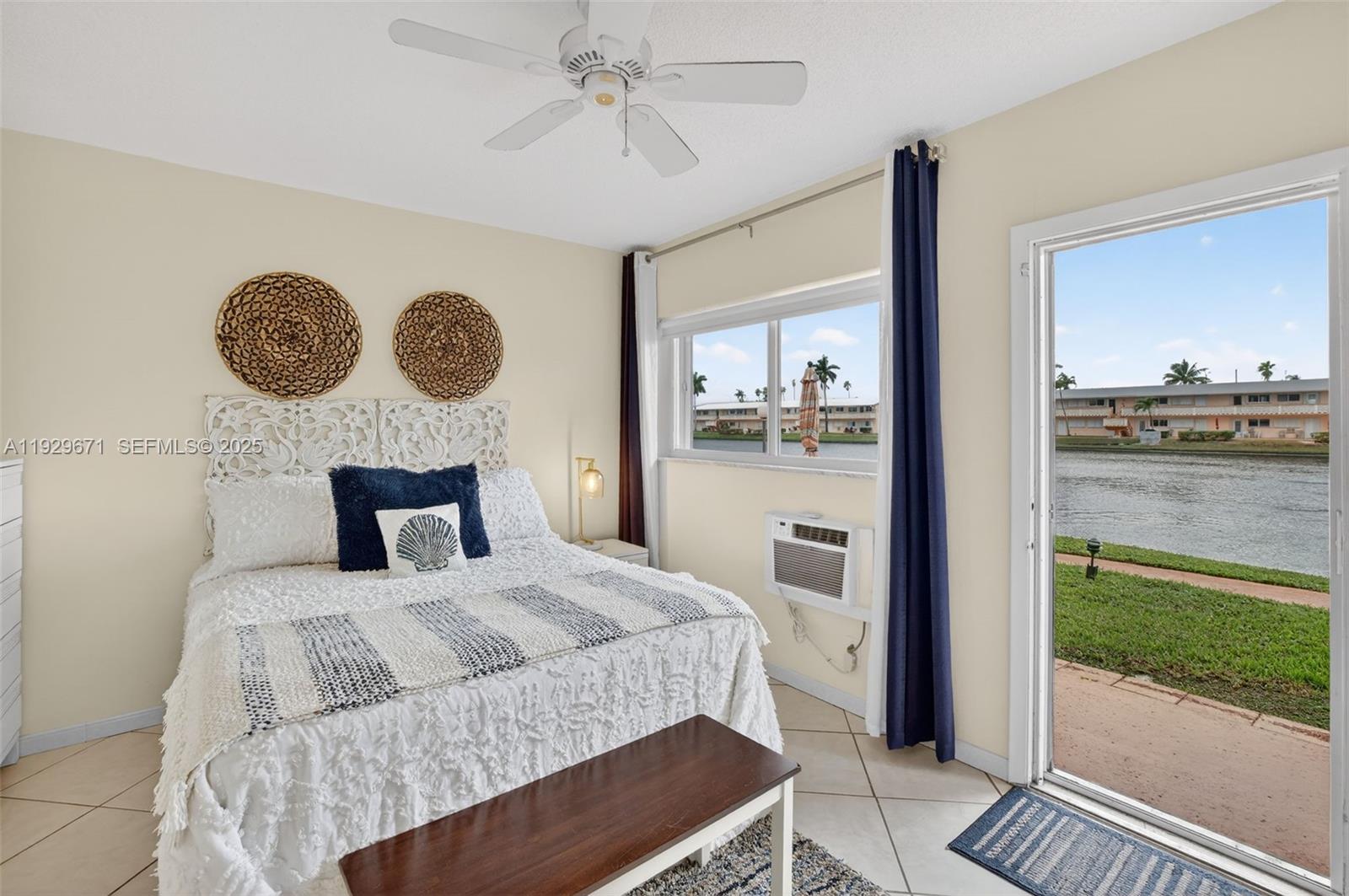 800 Southwest 10th Terrace, Unit 4T Hallandale Beach, FL 33009 - Photo 13 of 39 a bedroom with a bed and a chandelier