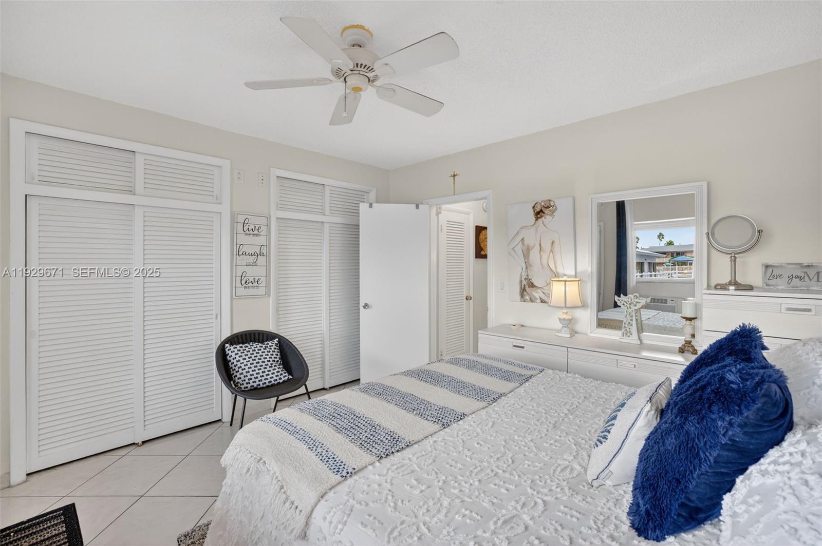 800 Southwest 10th Terrace, Unit 4T Hallandale Beach, FL 33009 - Photo 15 of 39 a spacious bedroom with a bed and a chandelier