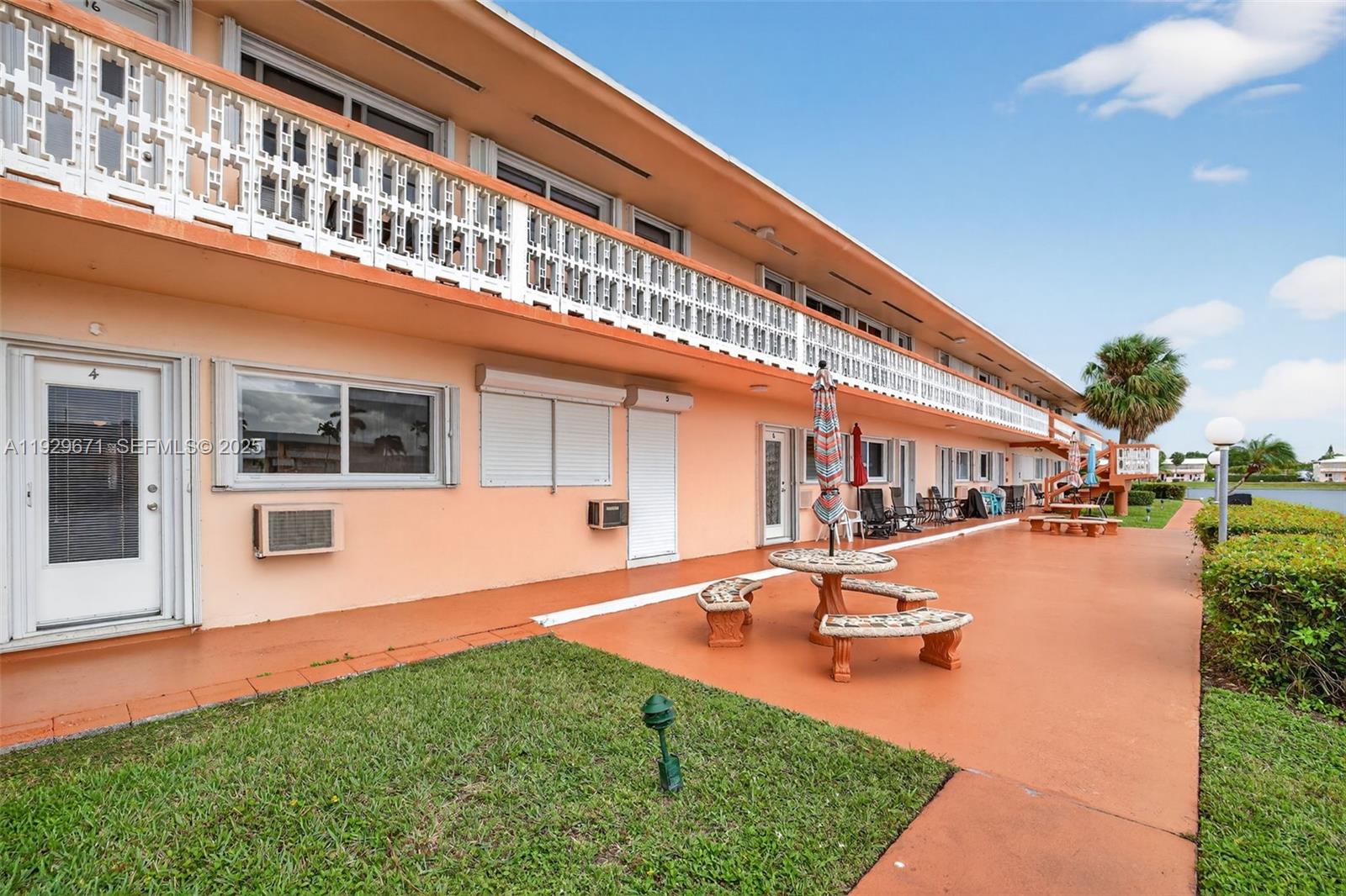 800 Southwest 10th Terrace, Unit 4T Hallandale Beach, FL 33009 - Photo 22 of 39 a swimming pool with outdoor seating and yard