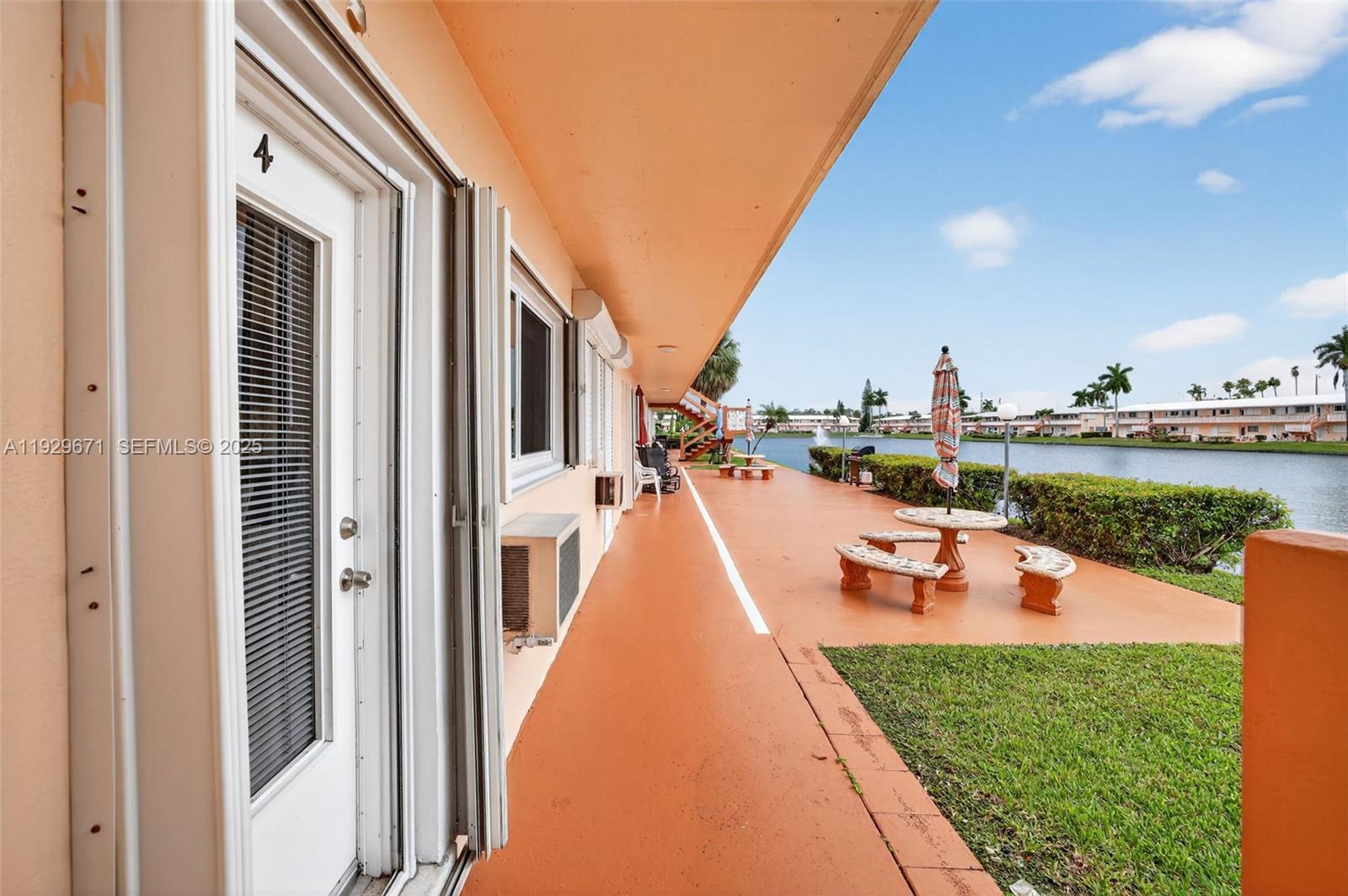 800 Southwest 10th Terrace, Unit 4T Hallandale Beach, FL 33009 - Photo 23 of 39 a view of a house with swimming pool and a garden