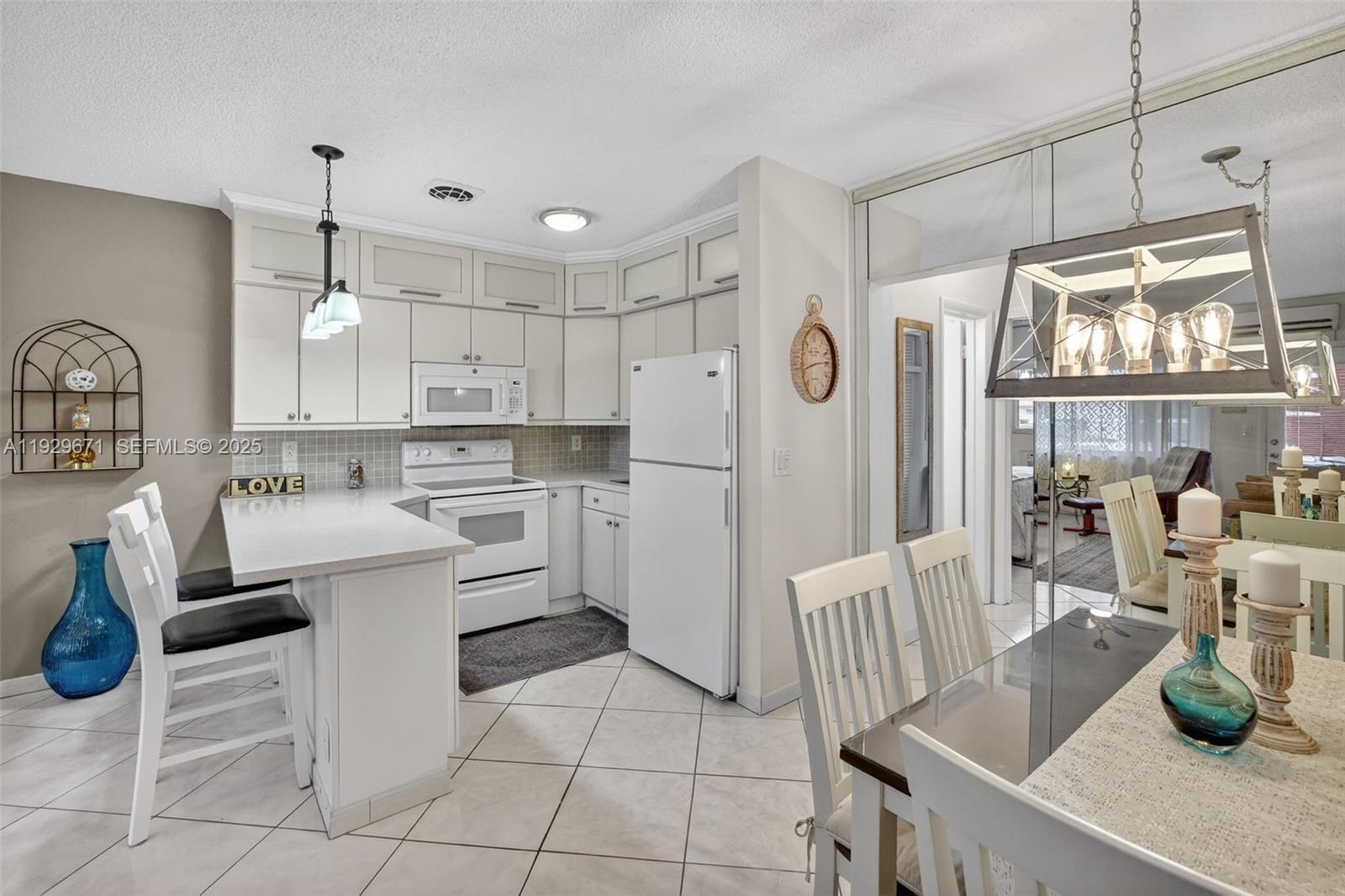 800 Southwest 10th Terrace, Unit 4T Hallandale Beach, FL 33009 - Photo 4 of 39 a kitchen with white cabinets and stainless steel appliances