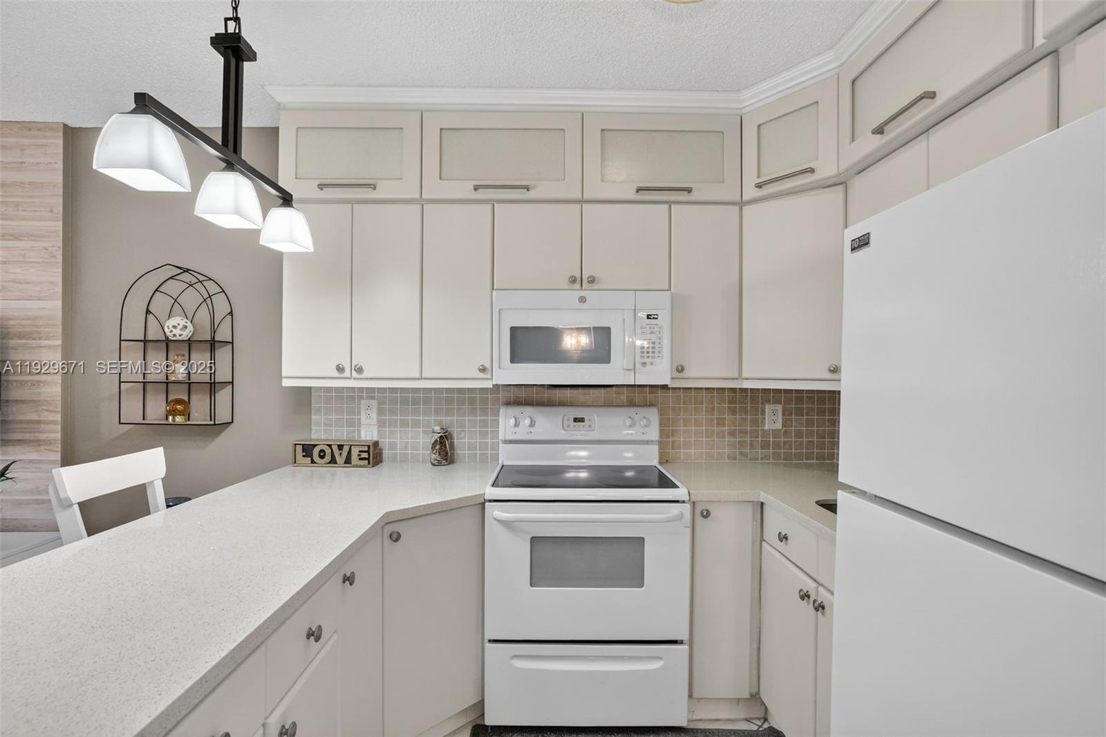 800 Southwest 10th Terrace, Unit 4T Hallandale Beach, FL 33009 - Photo 6 of 39 a kitchen with white cabinets and white appliances