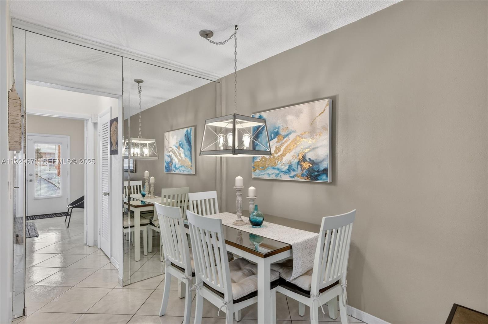 800 Southwest 10th Terrace, Unit 4T Hallandale Beach, FL 33009 - Photo 10 of 39 a view of a dining room with furniture a chandelier and wooden floor