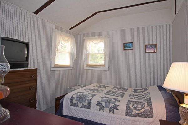 9 Island Road Ashburnham, MA 01430 - Photo 7 of 11 a bedroom with a bed and a flat tv screen on the dresser
