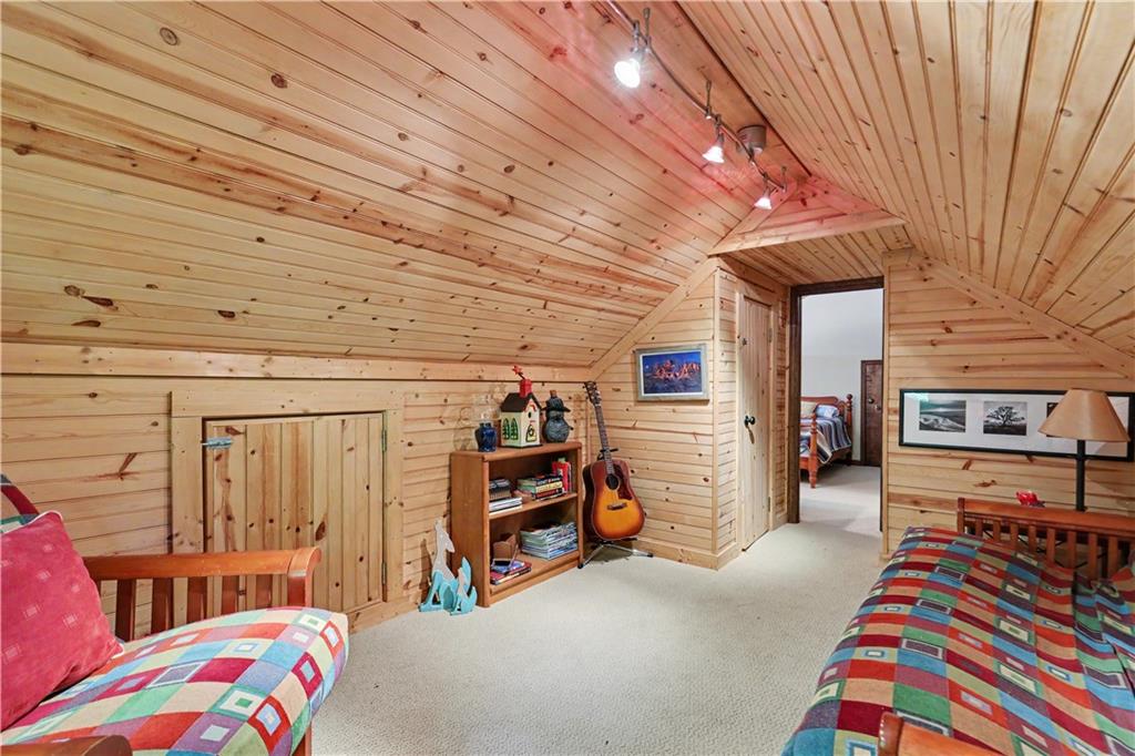 102 Moses Road Rabun Gap, GA 30568 - Photo 25 of 40 a bedroom with furniture and a tv