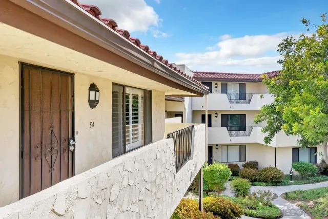 a view of a balcony with wooden floor and fence and a porch