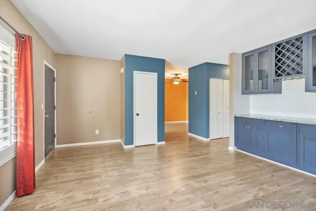 a view of a big room with wooden floor and cabinet